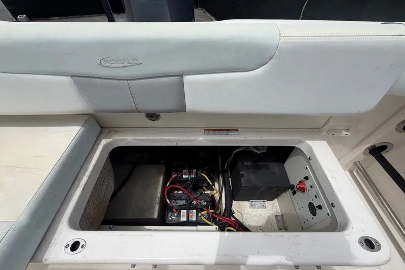 Slide: The Image of 2019 Robalo R222 Center Console boat battery compartment with wiring and storage. - 61