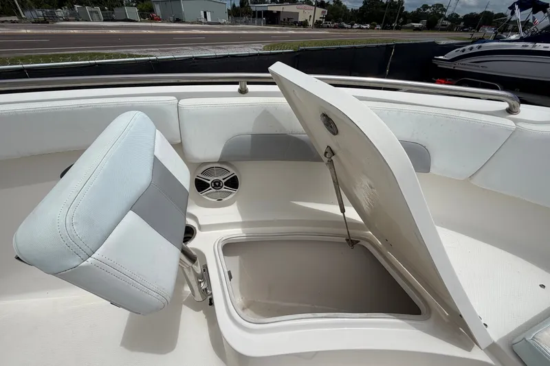 Slide: The Image of 2019 Robalo R222 Center Console boat with open storage compartment and cushioned seating. - 38