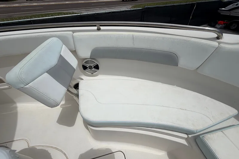 Slide: The Image of 2019 Robalo R222 Center Console boat seating area with cushioned seats and speaker. - 36