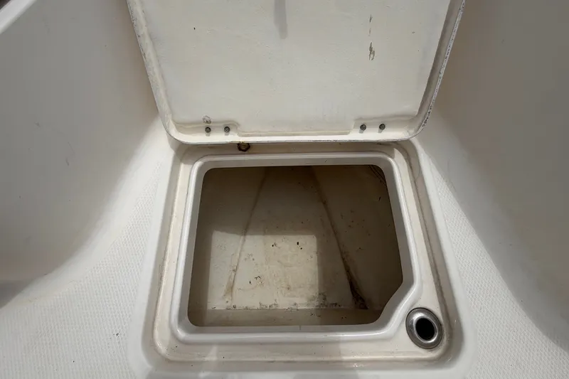 Slide: The Image of An open storage compartment on a boat with a drain hole at the bottom. - 35