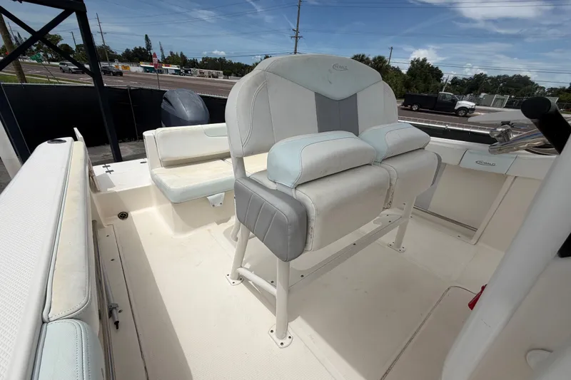 Slide: The Image of 2019 Robalo R222 Center Console boat interior with cushioned seating and console view. - 55