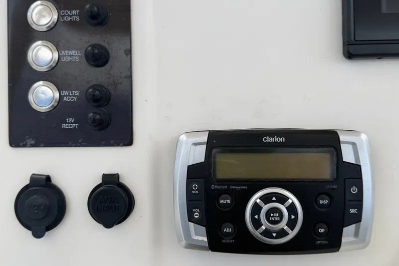 Slide: The Image of Control panel and Clarion audio system on 2019 Robalo R222 Center Console boat. - 24