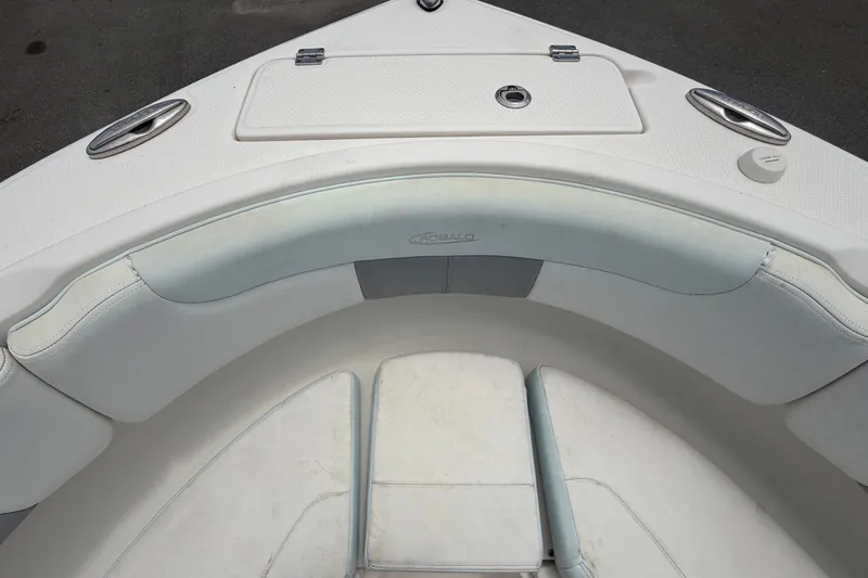 Slide: The Image of The bow of a Robalo R222 Center Console boat with cushioned seating and storage compartment. - 39