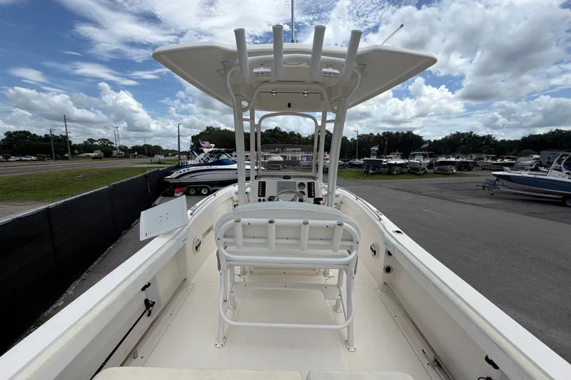 Slide: The Image of 2019 Robalo R222 Center Console boat with T-top, docked under cloudy sky. - 14