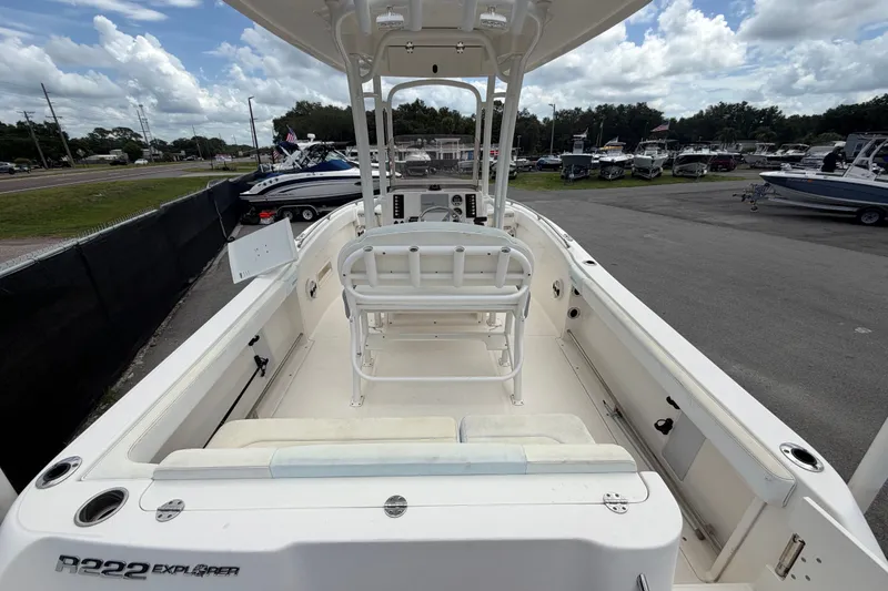 Slide: The Image of 2019 Robalo R222 Center Console boat with spacious deck and seating, parked outdoors. - 12