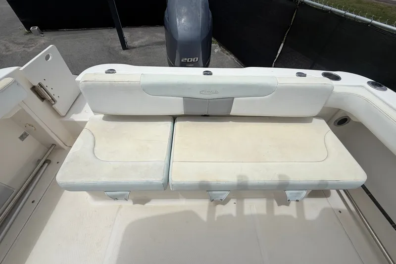 Slide: The Image of 2019 Robalo R222 Center Console boat seating area with white cushioned bench. - 58