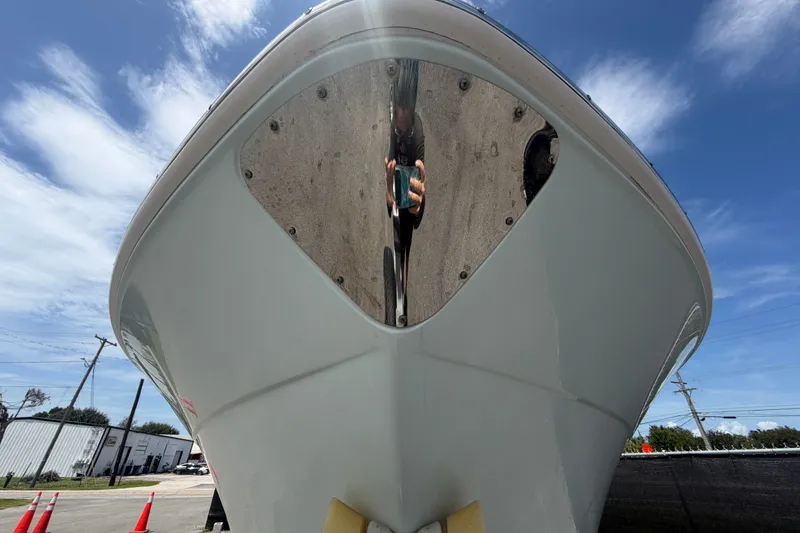 Slide: The Image of 2019 Robalo R222 Center Console boat, front view under clear blue sky. - 10