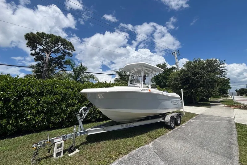 Slide: The Image of 2019 Robalo R222 Center Console boat on trailer under clear blue sky. - 3