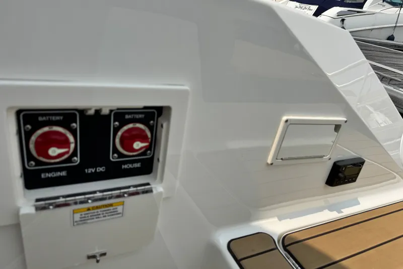 Slide: The Image of Battery switches on a 2022 Sea Ray SLX 280 boat deck. - 25
