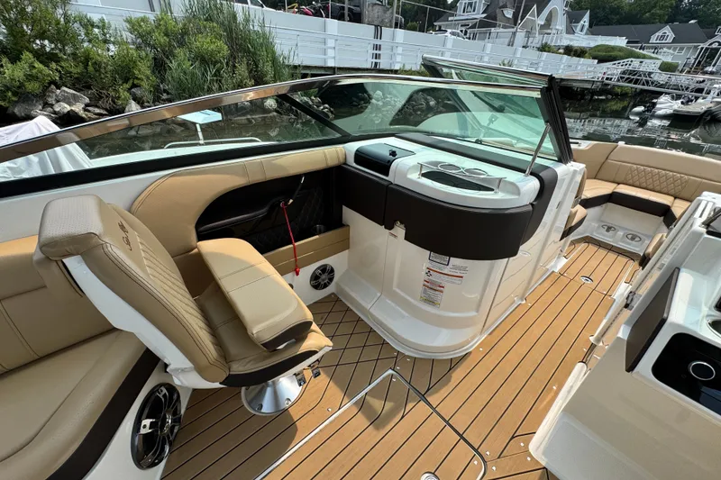 Slide: The Image of Luxurious 2022 Sea Ray SLX 280 boat interior with tan seating and sleek design. - 13