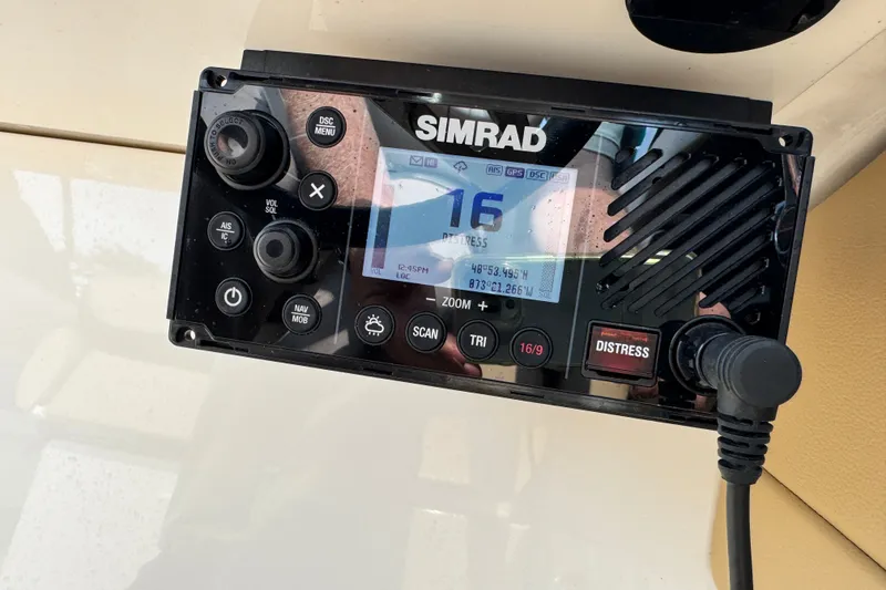 Slide: The Image of Simrad marine radio on 2022 Sea Ray SLX 280 boat dashboard. - 12
