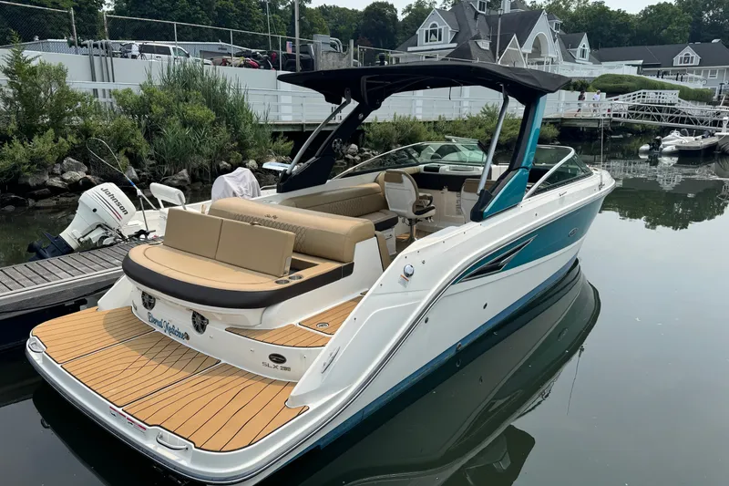 The Image of 2022 Sea Ray SLX 280 boat docked, featuring sleek design and spacious seating. - 3
