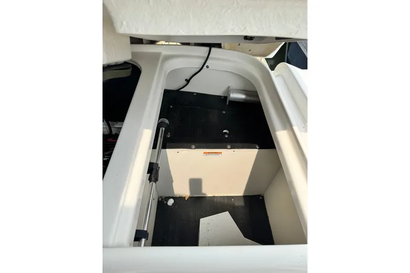Slide: The Image of Storage compartment of a 2022 Sea Ray SLX 280 boat, featuring hydraulic support. - 24