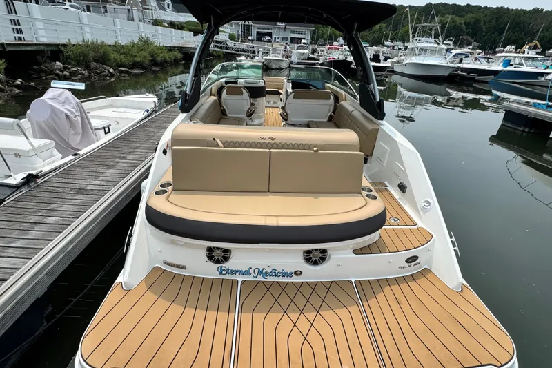Slide: The Image of 2022 Sea Ray SLX 280 boat docked, featuring spacious seating and elegant design. - 5
