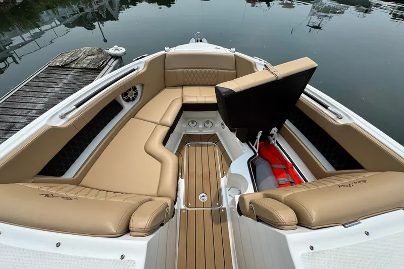 Slide: The Image of Luxurious 2022 Sea Ray SLX 280 boat interior with tan leather seating and wooden flooring. - 15