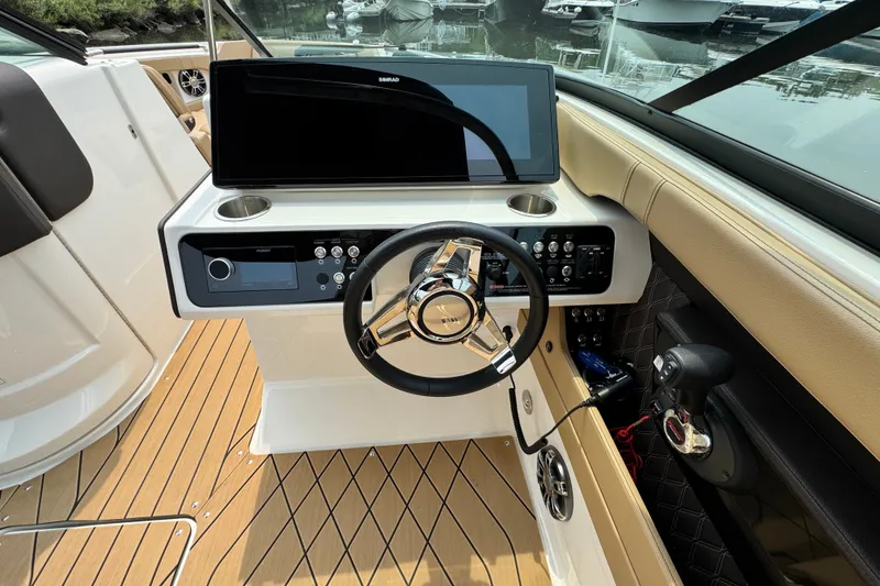 Slide: The Image of 2022 Sea Ray SLX 280 helm with modern controls and sleek steering wheel design. - 9