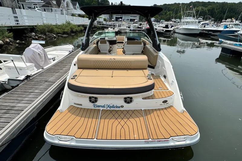 Slide: The Image of 2022 Sea Ray SLX 280 boat docked, featuring spacious seating and elegant design. - 6