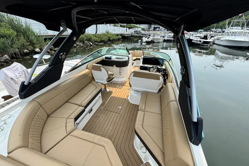 Slide: The Image of 2022 Sea Ray SLX 280 boat interior with tan seating and modern dashboard. - 7