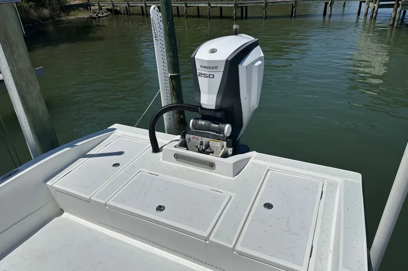 Slide: The Image of 2016 Shallow Sport 24 Modified V boat with Evinrude 250 outboard motor docked by water. - 22