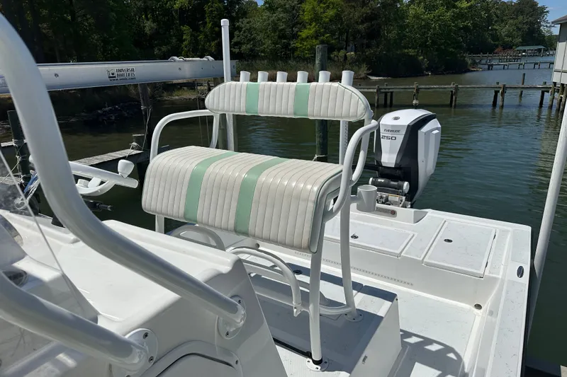Slide: The Image of 2016 Shallow Sport 24 Modified V boat with seating and Evinrude 250 engine at dock. - 21