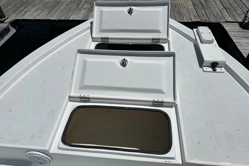 Slide: The Image of 2016 Shallow Sport 24 Modified V boat with open storage compartments on deck. - 20