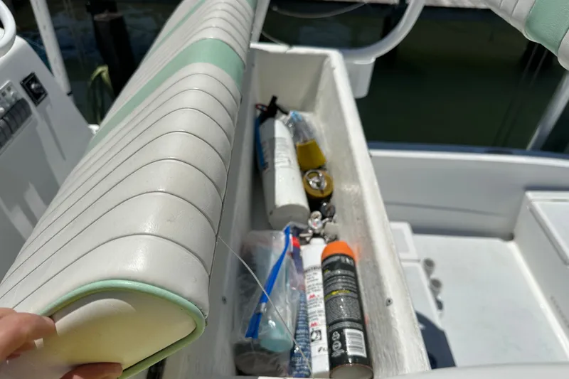 Slide: The Image of Storage compartment on a 2016 Shallow Sport 24 Modified V boat with safety gear. - 24