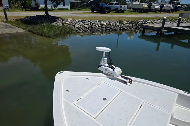Slide: The Image of 2016 Shallow Sport 24 Modified V boat with Minn Kota trolling motor at dock. - 19