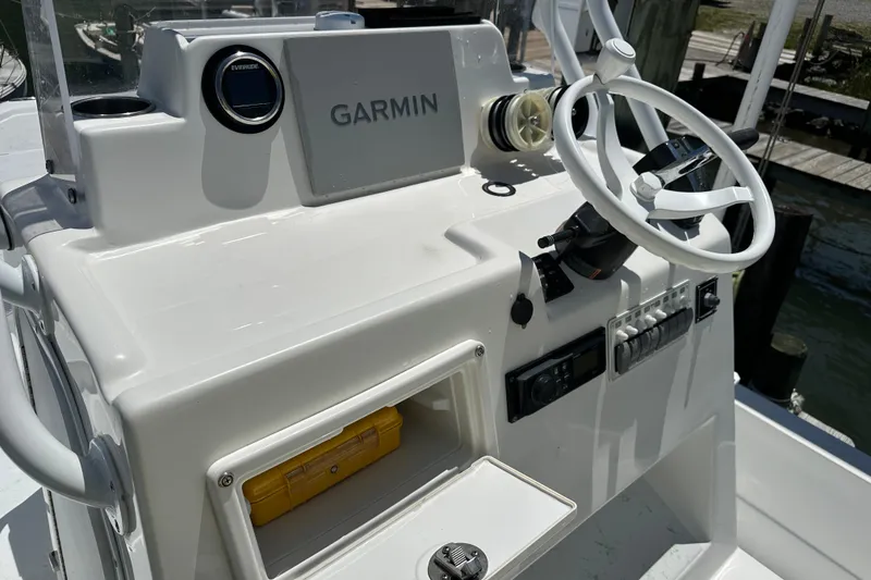 Slide: The Image of 2016 Shallow Sport 24 Modified V boat console with Garmin navigation and steering wheel. - 27