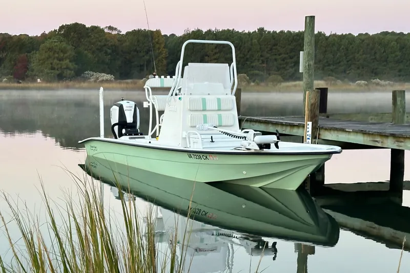 The Image of 2016 Shallow Sport 24 Modified V boat docked on calm water at sunrise. - 1