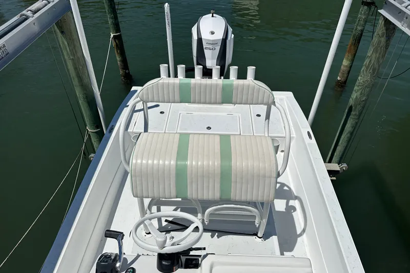 Slide: The Image of 2016 Shallow Sport 24 Modified V boat with Evinrude engine, docked in calm waters. - 23