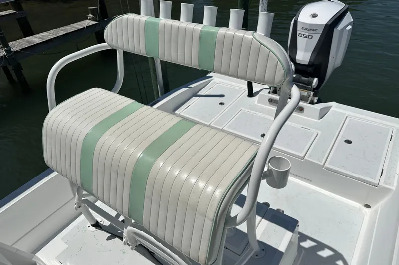 Slide: The Image of 2016 Shallow Sport 24 Modified V boat with white and green seating, Evinrude 250 engine. - 25