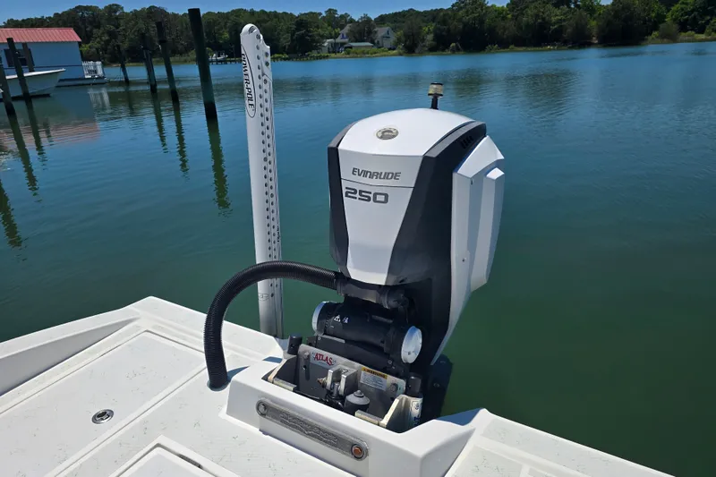Slide: The Image of 2016 Shallow Sport 24 Modified V boat with Evinrude 250 engine on calm water. - 16
