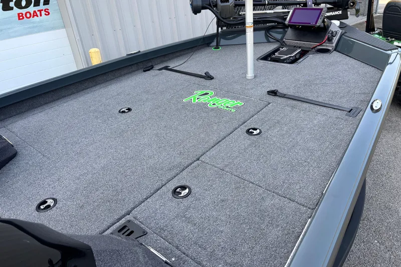 Slide: The Image of 2025 Ranger RT198P boat deck with carpeted surface and fishing equipment. - 5