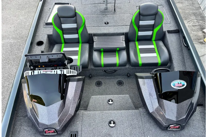 Slide: The Image of 2025 Ranger RT198P boat interior with dual seats, green accents, and modern dashboard. - 8