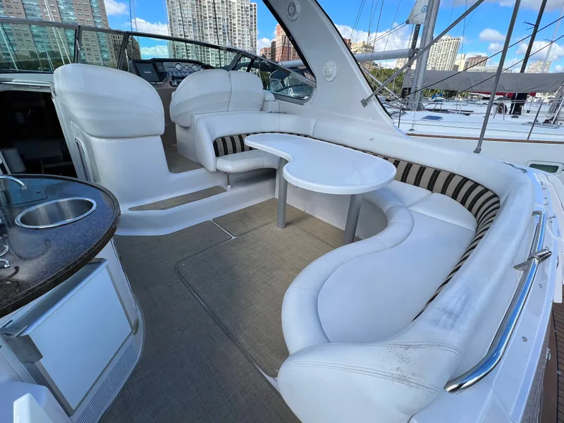 Slide: The Image of The image shows the cockpit of a 2006 Four Winns 378 Vista with white cushioned seating and a table. - 1