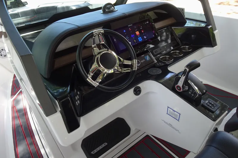 Slide: The Image of 2025 Monterey Elite 27 OB boat dashboard with modern steering and digital controls. - 18