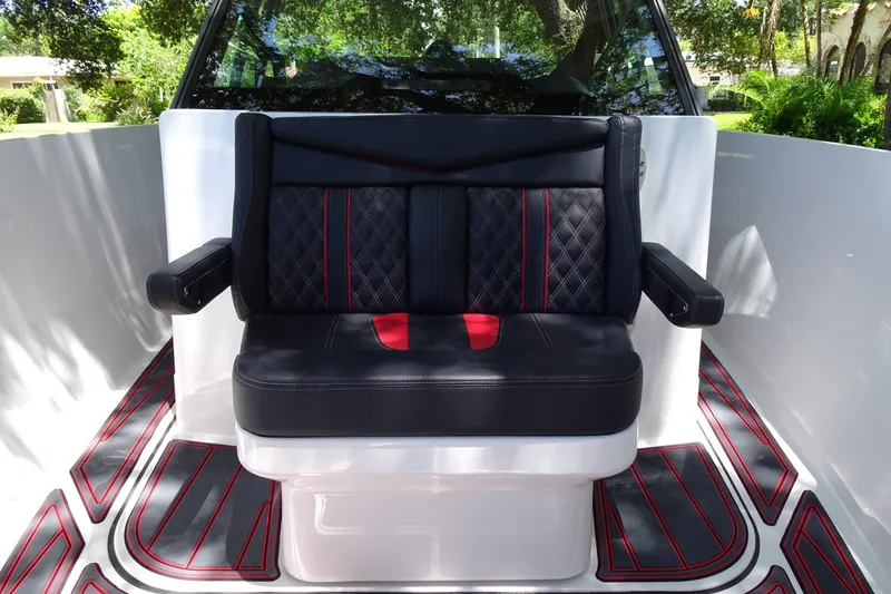 Slide: The Image of Luxurious seating on 2025 Monterey Elite 27 OB boat with stylish black and red upholstery. - 26