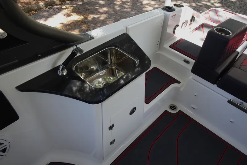 Slide: The Image of Interior of 2025 Monterey Elite 27 OB boat featuring a sleek sink and seating area. - 14
