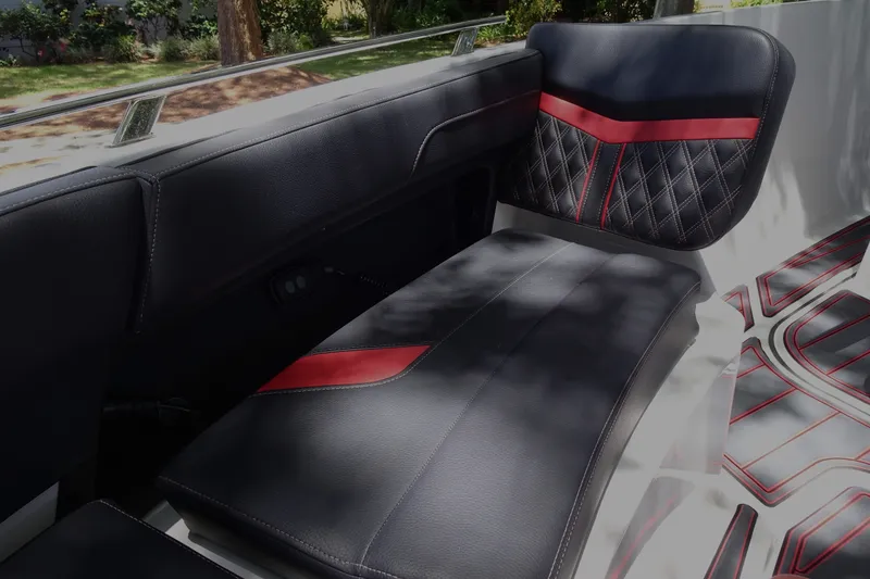 Slide: The Image of Luxurious seating in the 2025 Monterey Elite 27 OB boat with black and red accents. - 24