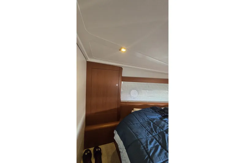 Slide: The Image of Interior cabin of 2013 Beneteau Gran Turismo 38 yacht with wooden paneling and bedding. - 28