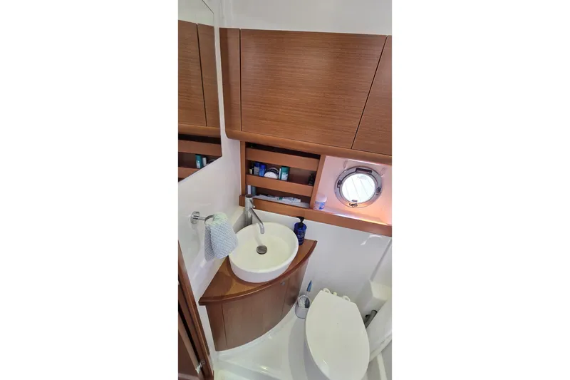 Slide: The Image of Bathroom interior of 2013 Beneteau Gran Turismo 38 yacht with sink and porthole. - 33