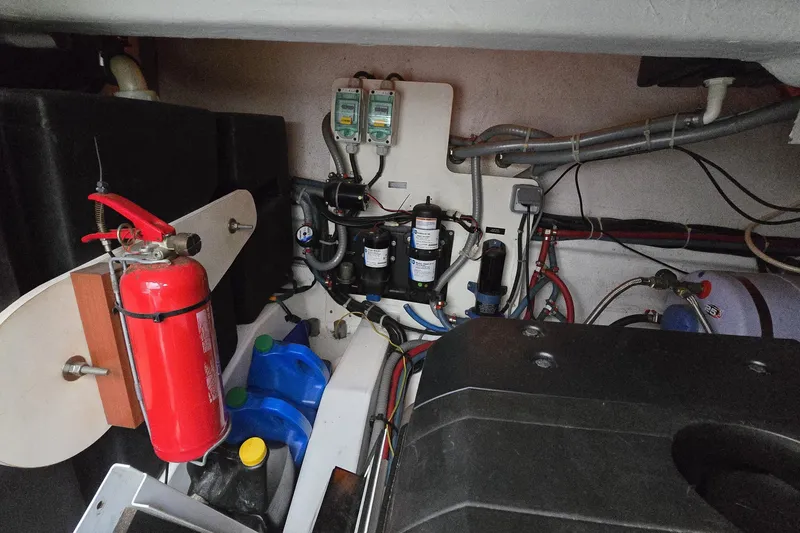 Slide: The Image of Engine room of 2013 Beneteau Gran Turismo 38 with fire extinguisher and mechanical components. - 40