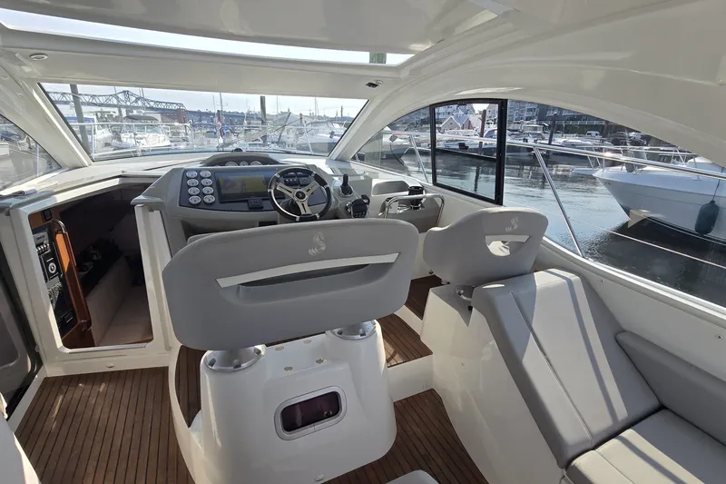 Slide: The Image of Interior view of 2013 Beneteau Gran Turismo 38 yacht, featuring modern helm and seating. - 15