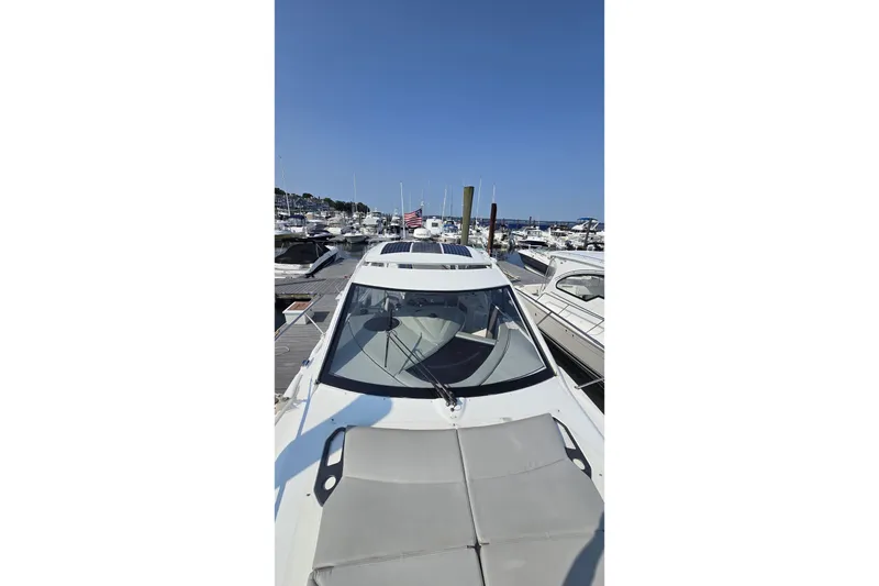 Slide: The Image of 2013 Beneteau Gran Turismo 38 yacht docked at a marina under clear blue skies. - 37