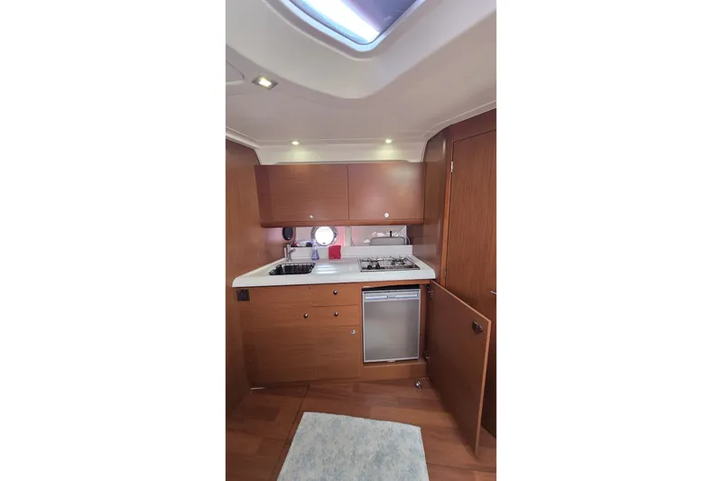 Slide: The Image of Interior of 2013 Beneteau Gran Turismo 38 yacht kitchen with wood cabinetry and modern appliances. - 24