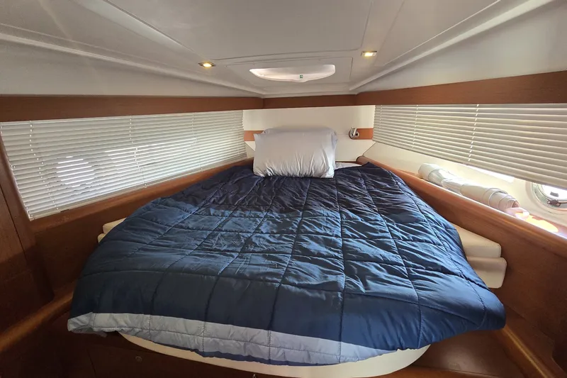 Slide: The Image of Cabin interior of 2013 Beneteau Gran Turismo 38 with cozy bed and blue bedding. - 29