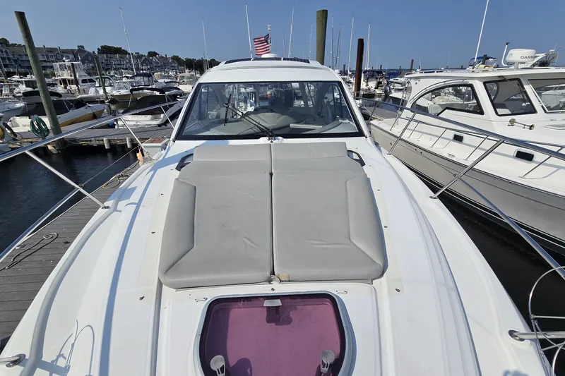 Slide: The Image of 2013 Beneteau Gran Turismo 38 yacht docked at marina, featuring spacious deck and sleek design. - 36