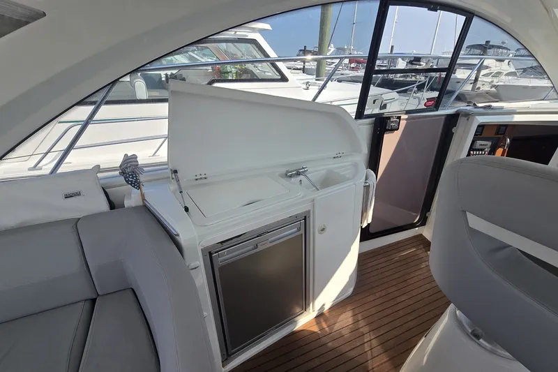 Slide: The Image of Interior of 2013 Beneteau Gran Turismo 38 yacht with kitchenette and seating area. - 14