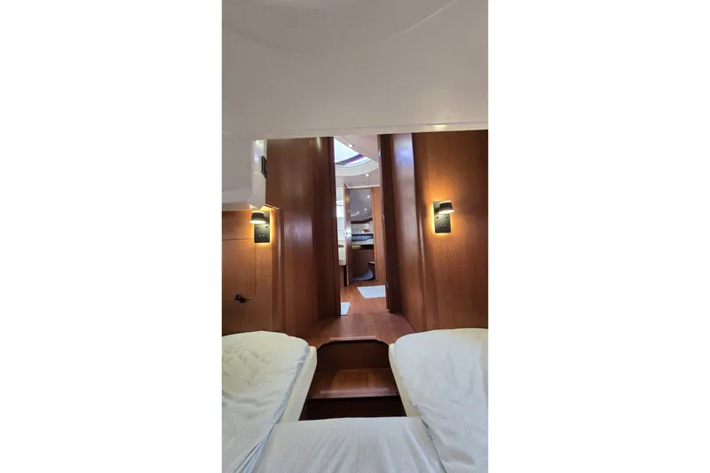 Slide: The Image of Interior view of 2013 Beneteau Gran Turismo 38 yacht, featuring elegant wood paneling and cozy lighting. - 31