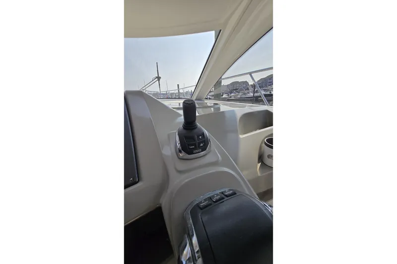 Slide: The Image of Control panel of a 2013 Beneteau Gran Turismo 38 yacht, featuring joystick and dashboard. - 17